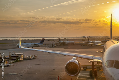 New York City - April 2009: Airplanes at sunset along the runway at JFK international airport
