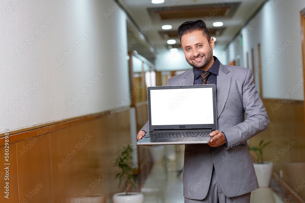 Indian businessman showing blank laptop screen. Indian businessman showing blank laptop screen.