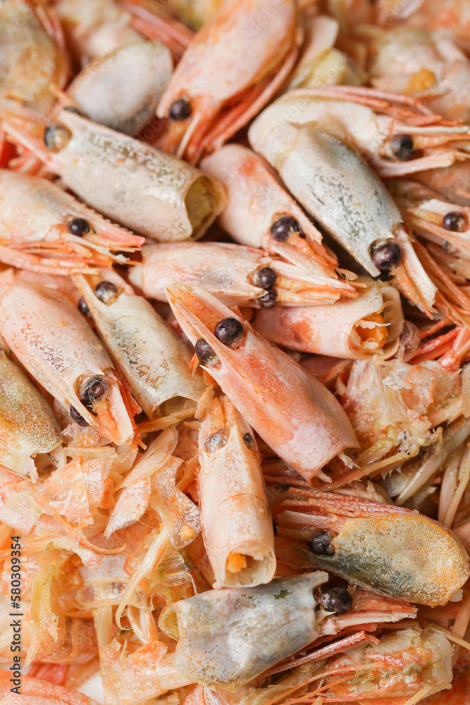 remains of shrimp shells on a plate, leftover food