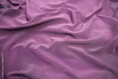 background and texture of wavy bright purple fabric