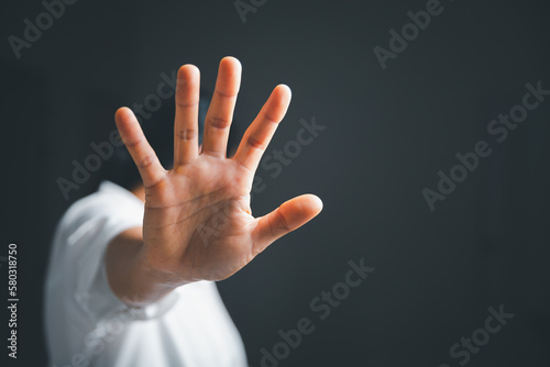 Stop violence against women concept, international women's day. Female hand raised in fear and stop sexual harassment. Women are depressed by bullying and abuse. family threat photo