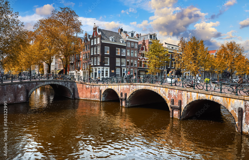 Bridge over channel in Amsterdam Netherlands houses river Amstel landmark old european city spring landscape