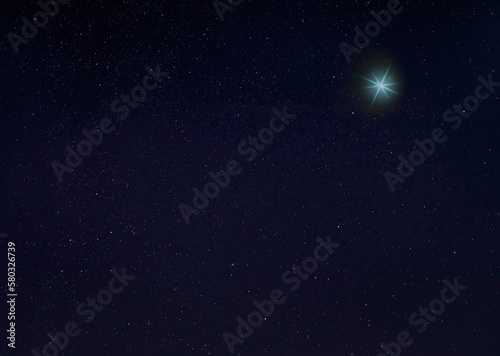 Bright blue star in the night sky