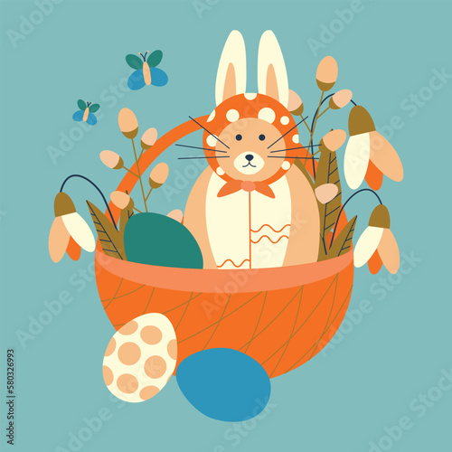 Easter basket with eggs, a cat with rabbit ears, and snowdrop flowers.