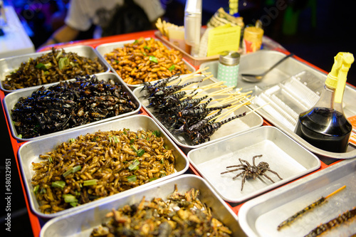 Exotic food in Khao San road at night in Bangkok city, Thailand, Holidays and traveling concept photo