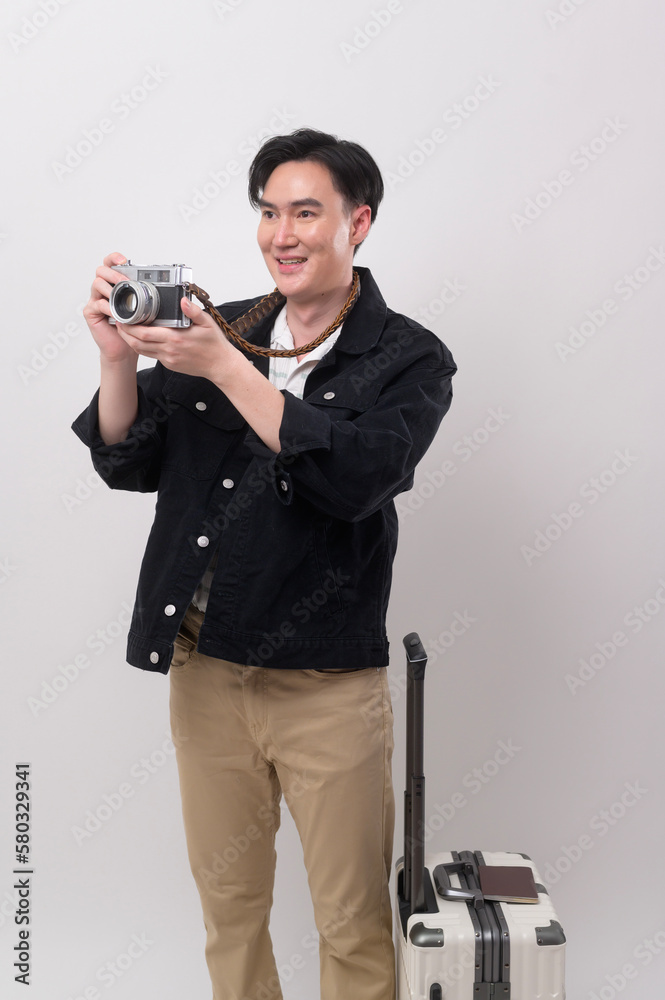 Young happy asian tourist man over white background studio, travel and holidays concept. Young happy asian tourist man over white background studio, travel and holidays concept.