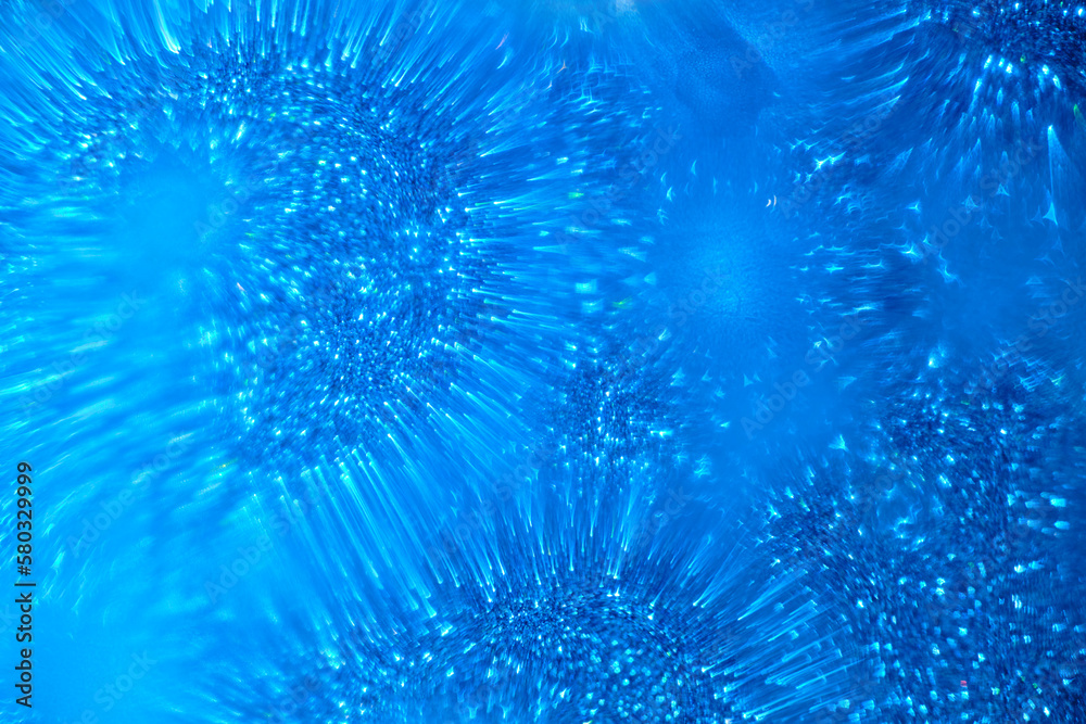 Fototapeta premium Abstract blue background with blurred shiny shapes.
