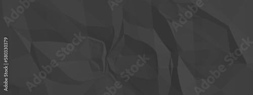 Black creased crumpled paper texture background. Black paper sheet texture. 