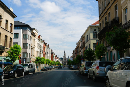 Brussels residential area city streets with cars parked on both sides of the street © Kaspars
