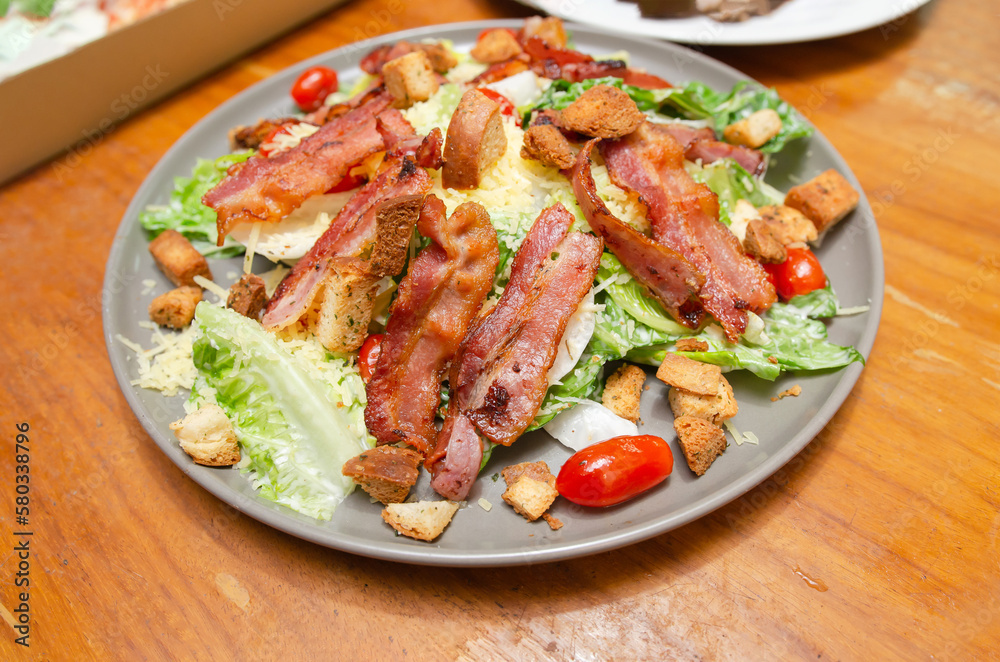 Salad with bacon and cheese and Caesar dressing Salad with bacon and cheese and Caesar dressing