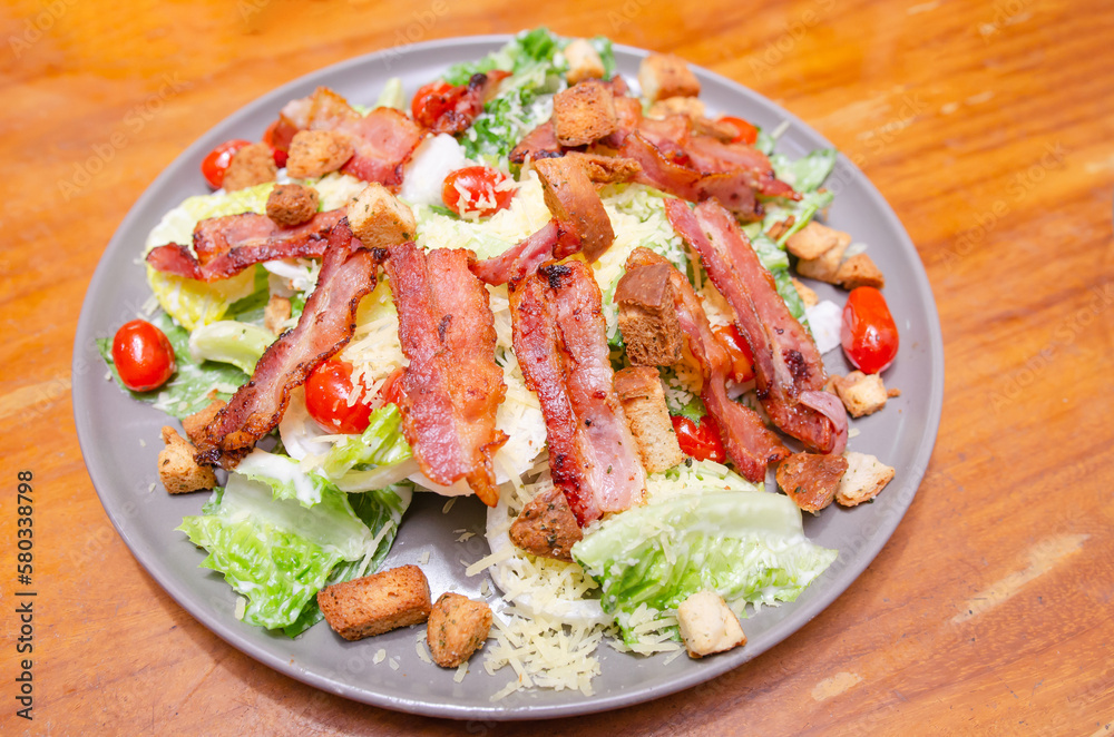 Salad with bacon and cheese and Caesar dressing