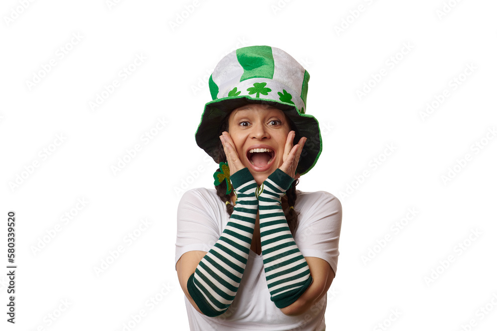 Charming woman dressed as Leprechaun in striped gloves and hat with clover leaves, for St Patrick's pub party, expressing amazement and surprise, looking at camera over isolated white background Charming woman dressed as Leprechaun in striped gloves and hat with clover leaves, for St Patrick's pub party, expressing amazement and surprise, looking at camera over isolated white background
