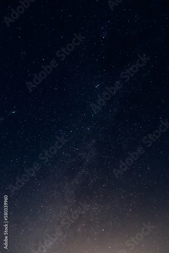The Milky Way Galaxy rises out of the last light of day and into the dark sky of the night.