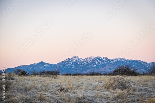 Distant mountain range with hills covered in grass in the forground in Arizona.