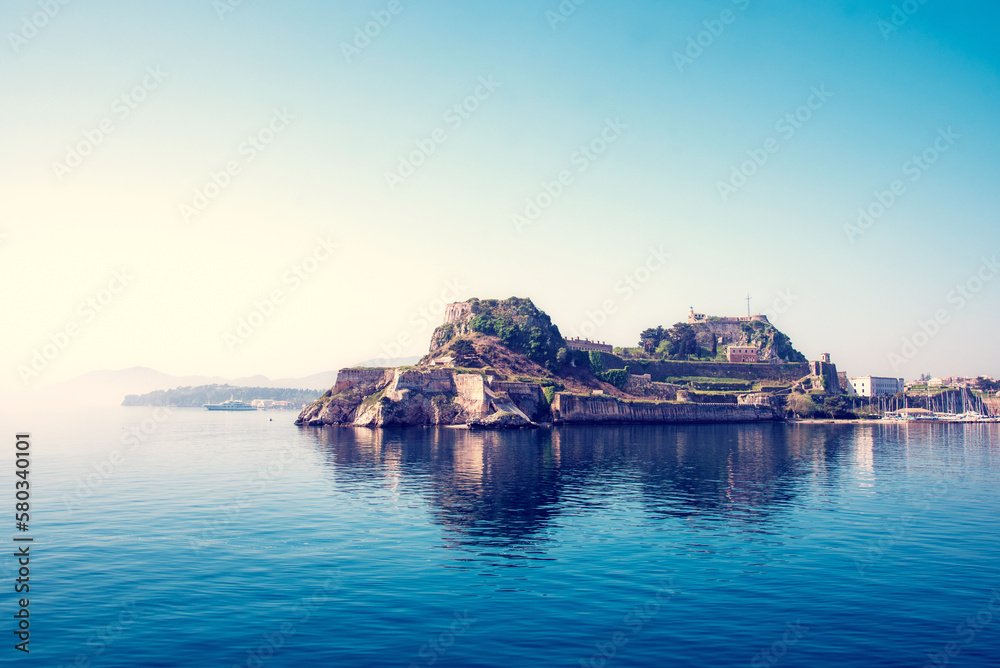 View of the fortress of Corfu from the sea in the morning mist with a steamer in the distance, Greece. Harmony, popular tourist attractions. amazing places.