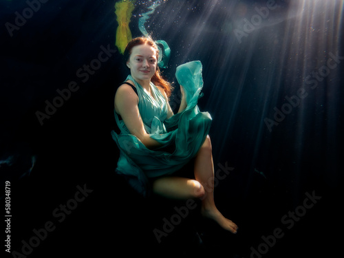 Reagan Swenson underwater with dress floating