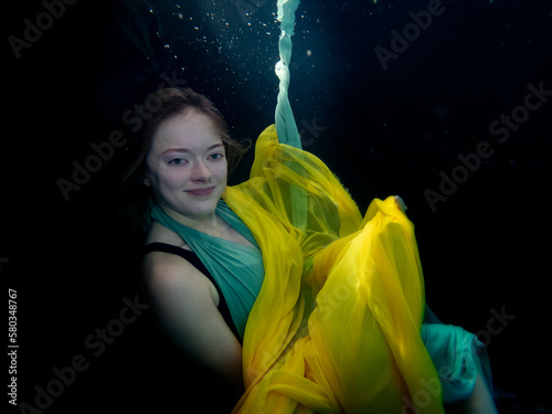 Reagan Swenson underwater with dress floating photo