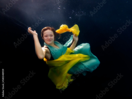 Reagan Swenson underwater with dress floating