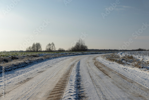Fototapeta Naklejka Na Ścianę i Meble -  A road covered with snow and ice for cars