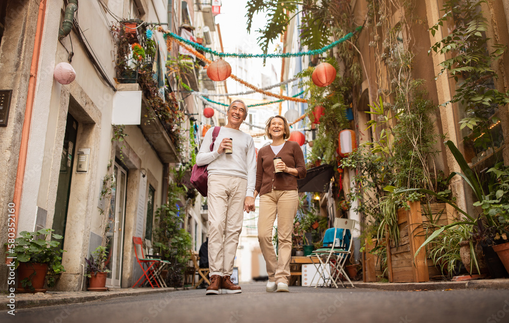 Cheerful Senior Travelers Couple Enjoying Walking In Lisbon Outside