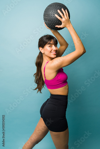 Rear view of an athletic sporty woman exercising with cross training © AntonioDiaz