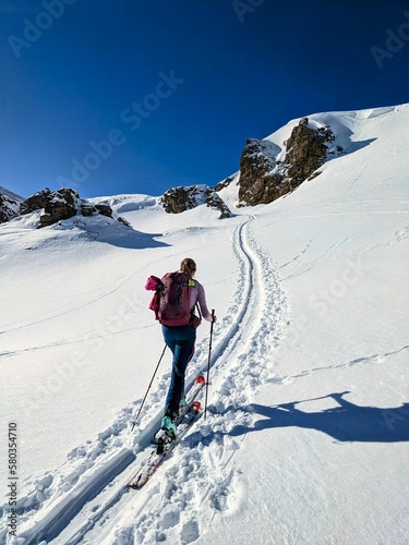 A woman on a ski tour towards Erdisgulmen in the Flumserberg. Ski climbing in beautiful Switzerland. High quality photo
