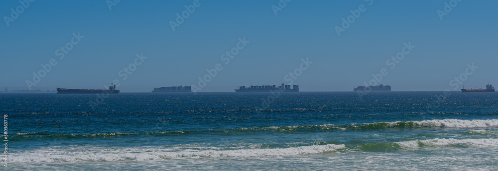 Container ship from shipping company Hamburg Sued and MAERSK Line with container anchored off Cape Town