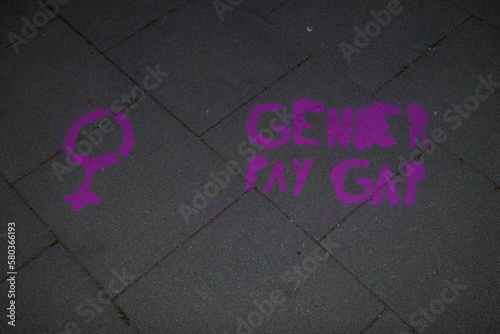 Graffiti on a sidewalk on occasion of international women's day, protesting against the gender payment gap. photo