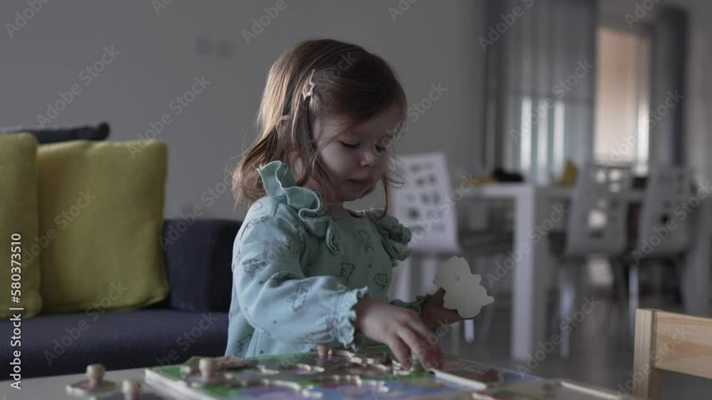 One girl caucasian toddler two years old play at the table at home One girl caucasian toddler two years old play at the table at home