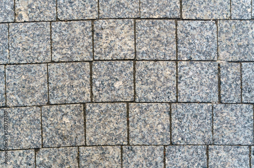 Abstract background of gray paving slabs from small stone  close-up.