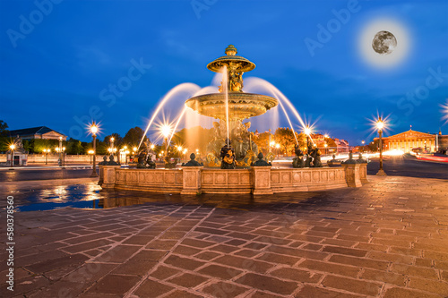 Fountain at the Place de la Concorde in Paris by night (with the moon), France
