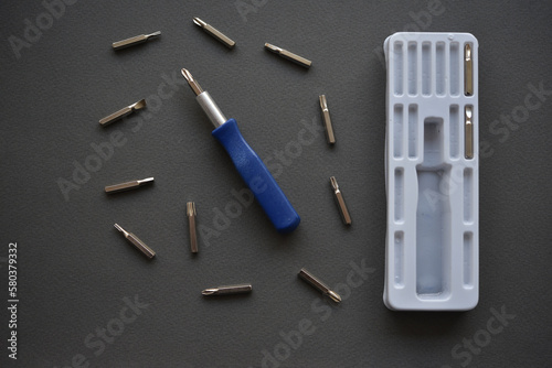 A set of screwdrivers with nozzles on a gray background. Replaceable nozzles for a screwdriver.