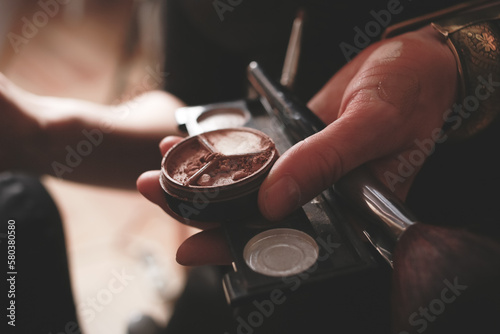 Woman holding a make up tools and powder cream close up