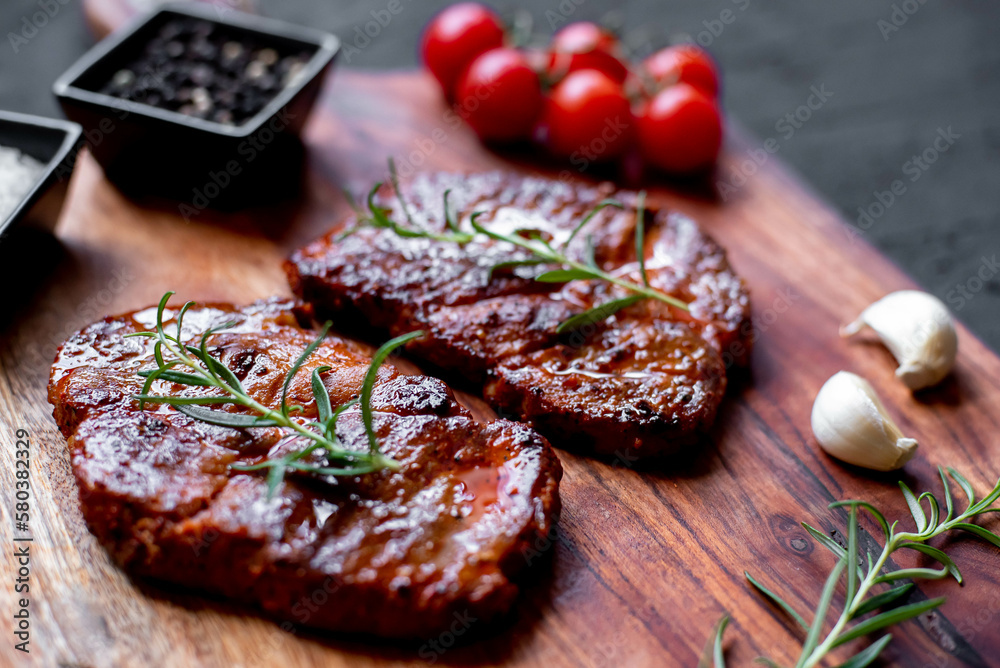 grilled pork steaks on stone background grilled pork steaks on stone background