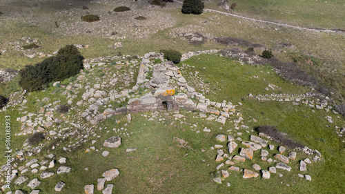 Archeological ruins of Nuragic necropolis Giants Tomb of S’omu de S’orcu - Tomba di Giganti Omu de Orcu - with front grave stones of Neolithic cemetery
 photo