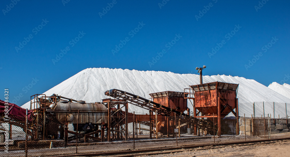 Picture of salt factory equipment and salt piles.