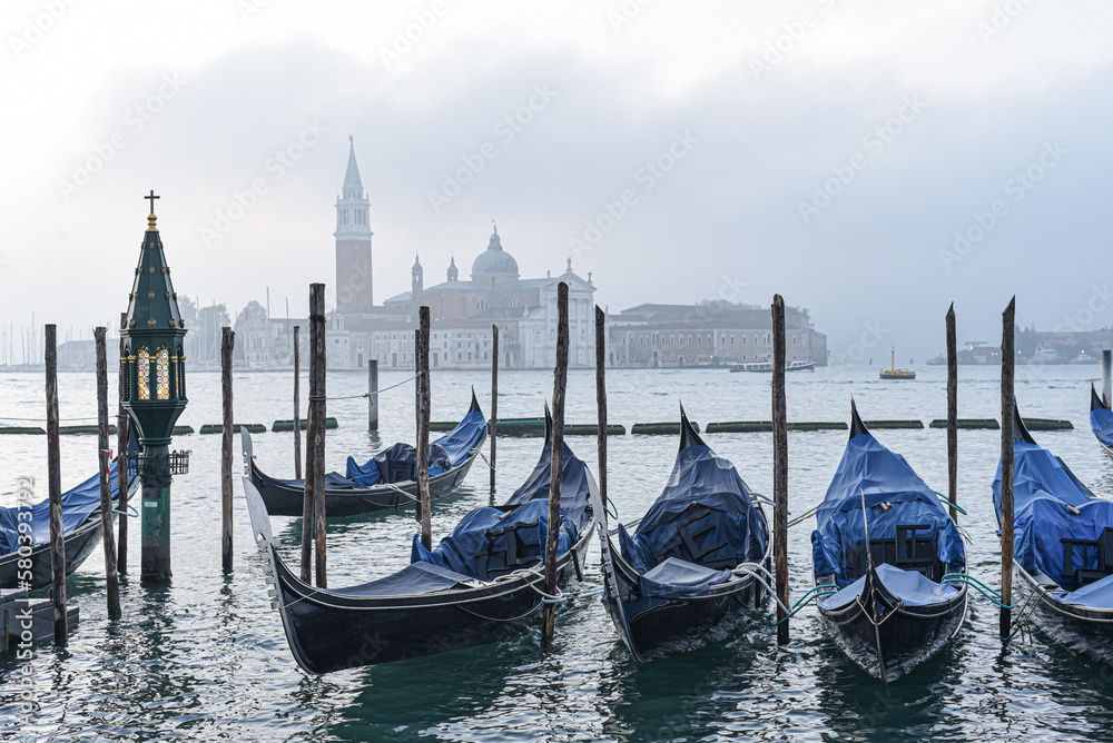 Venice, Italy - 15 Nov,  2022: Morning views of gondolas, the Grand Canal, and San Giorgio Bell Tower