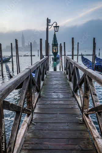 Venice, Italy - 15 Nov, 2022: Morning views of gondolas, the Grand Canal, and San Giorgio Bell Tower