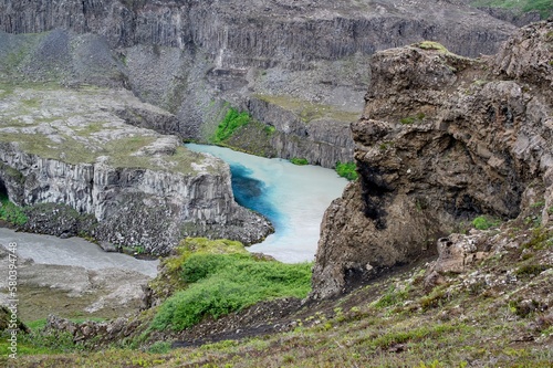 Lagoon near Hafragilsfoss waterfall at Jokulsa a Fjollum river in Iceland with dirty waters and clean azure stream photo