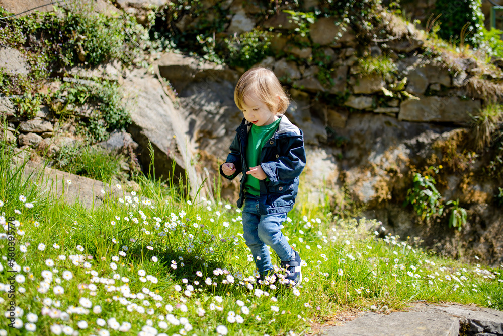 Cute toddler boy having fun exploring in Bellano town, located on the eastern shore of Lake Como in the Province of Lecco. Bellano, Italy. Cute toddler boy having fun exploring in Bellano town, located on the eastern shore of Lake Como in the Province of Lecco. Bellano, Italy.