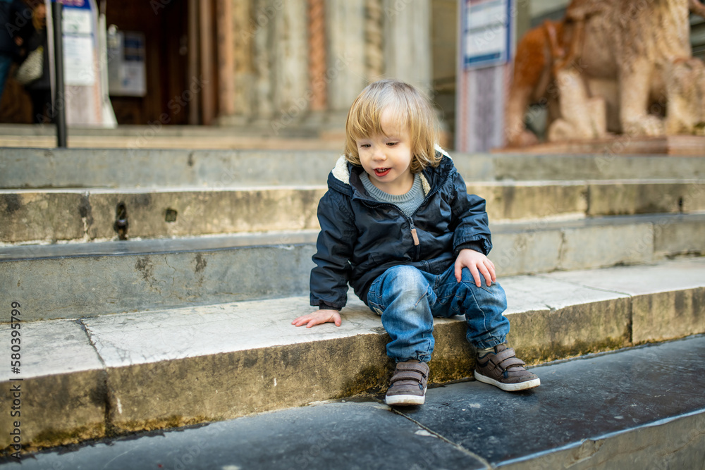 Cute toddler boy walking down the street of Bergamo. Little child having fun exploring in Citta Alta, upper district of Bergamo. Bergamo, Italy. Cute toddler boy walking down the street of Bergamo. Little child having fun exploring in Citta Alta, upper district of Bergamo. Bergamo, Italy.