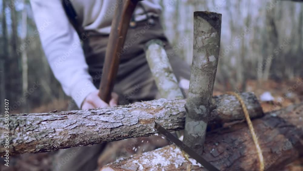 Man sawing a tree branch. Firewood for the winter. Wood for home heating. Chop wood, log. Man sawing a tree branch. Firewood for the winter. Wood for home heating. Chop wood, log.