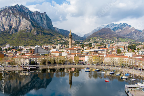 Sunny aerial cityscape of Lecco town on spring day. Picturesque waterfront of Lecco town located between famous Lake Como and scenic Bergamo Alps mountains. © MNStudio