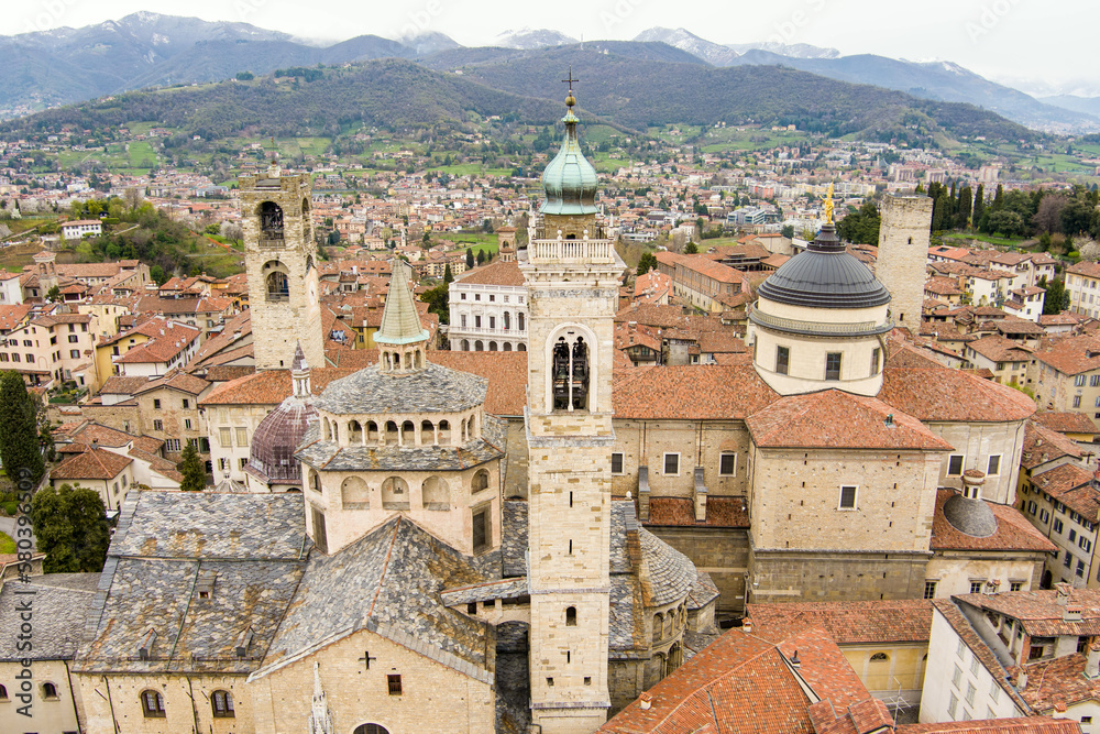 Scenic aerial view of Bergamo city. Flying over Citta Alta, town's upper district, known by cobblestone streets and encircled by Venetian walls. Bergamo, Lombardy, Italy.