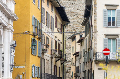 Fototapeta Naklejka Na Ścianę i Meble -  Narrow medieval streets of Bergamo city northeast of Milan. Scenic views of Citta Alta, town's upper district, known by cobblestone streets and encircled by Venetian walls. Bergamo, Italy.