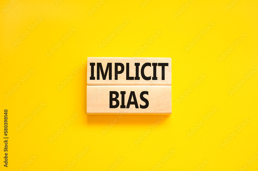 Implicit bias symbol. Concept words Implicit bias on wooden block. Beautiful yellow table yellow background. Business psychology implicit bias concept. Copy space. Implicit bias symbol. Concept words Implicit bias on wooden block. Beautiful yellow table yellow background. Business psychology implicit bias concept. Copy space.