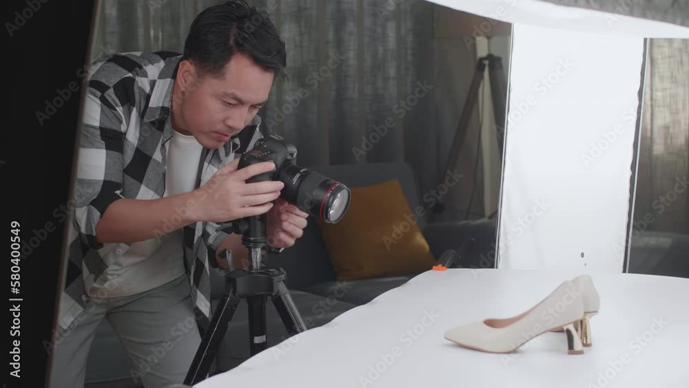 Asian Male Photographer Being Tired Taking Photos Of Women'S Shoes In Home Studio
Asian Male Photographer Being Tired Taking Photos Of Women'S Shoes In Home Studio