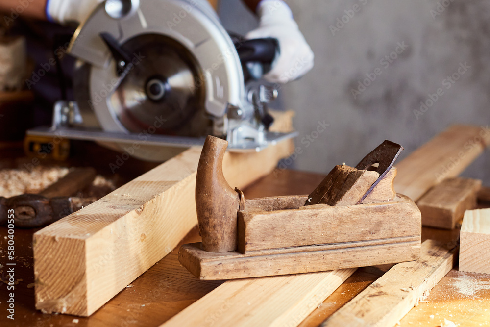 Skilled female carpenter using a circular saw. Woman worker in the carpenter workroom renovation. Small business concept Skilled female carpenter using a circular saw. Woman worker in the carpenter workroom renovation. Small business concept