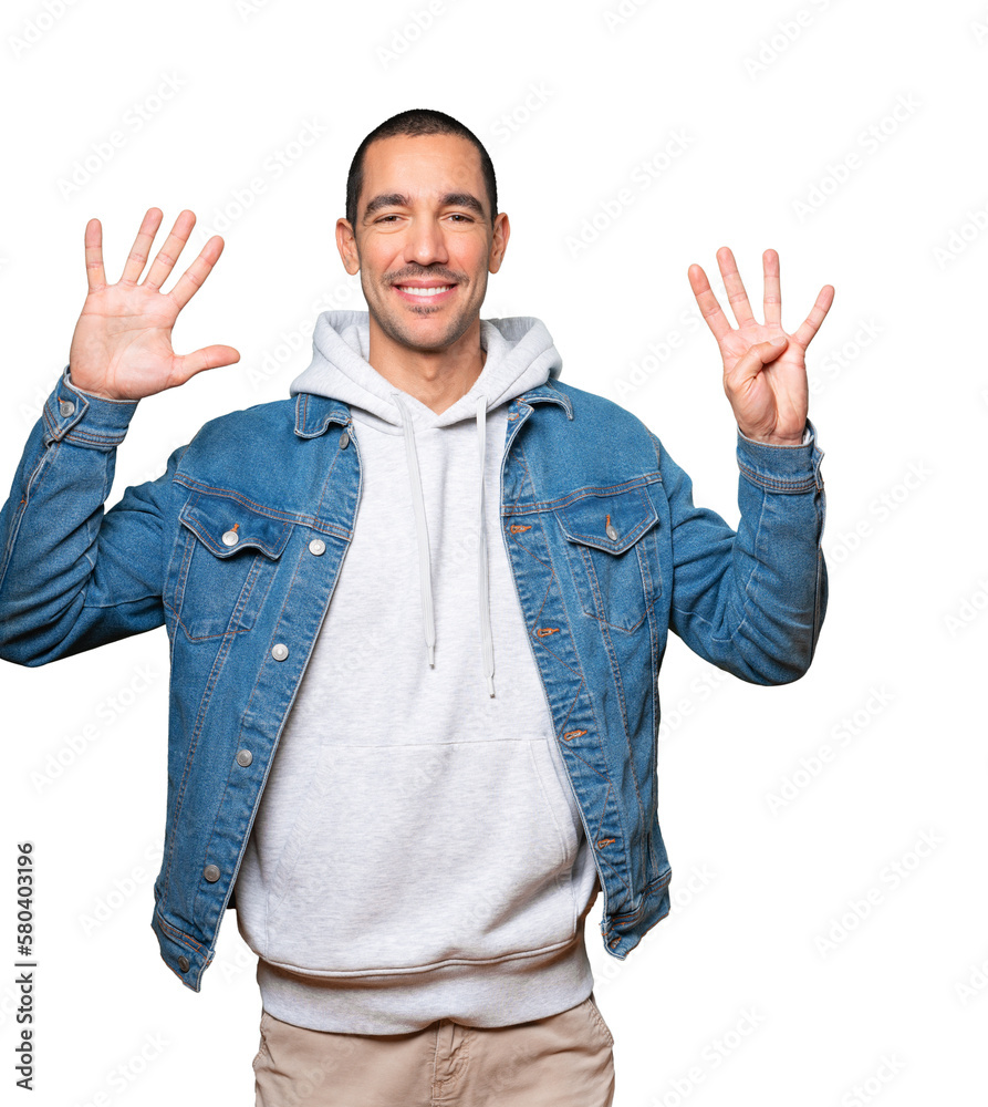 Happy young man doing a number nine gesture with his hands Happy young man doing a number nine gesture with his hands