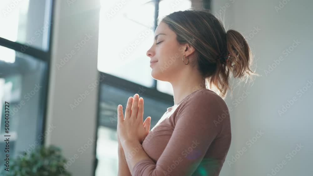 Video of pretty young woman giving thanks to the universe at living room at home. Video of pretty young woman giving thanks to the universe at living room at home.